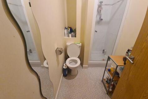 A compact and clean bathroom featuring a modern...