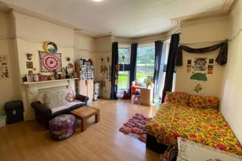 A spacious and cozy master bedroom featuring a ...