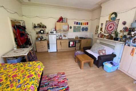 A cozy living room with a colorful and eclectic...