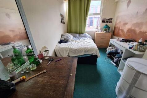 Cozy bedroom with a comfortable single bed, a d...