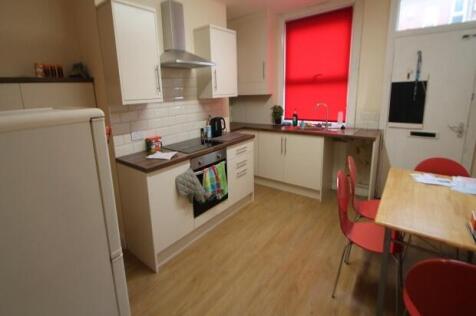Bright and modern kitchen featuring clean woode...