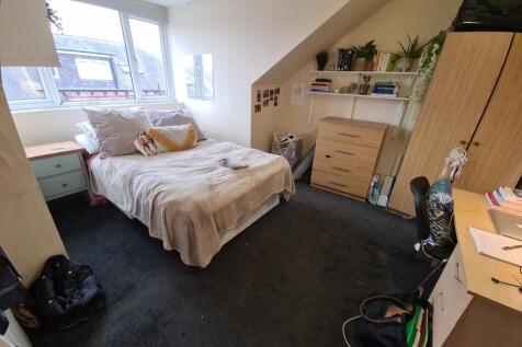 Cozy and well-lit single bedroom featuring a co...