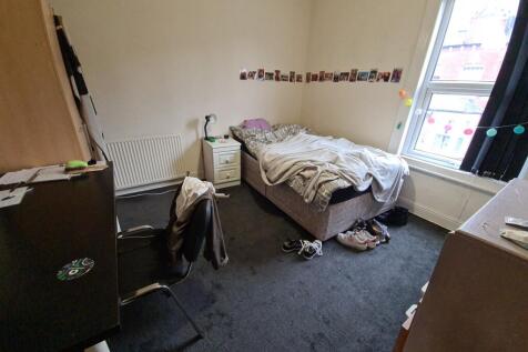 Cozy bedroom with a window providing natural li...