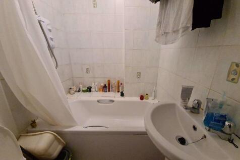 A compact, well-maintained bathroom featuring a...