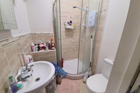Bright, modern bathroom with a corner shower, p...