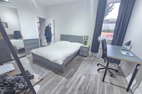 A bright and spacious master bedroom featuring ...