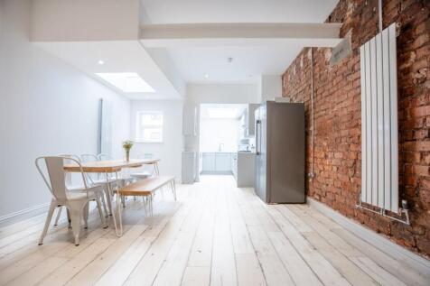 Bright, modern open-plan kitchen and dining are...