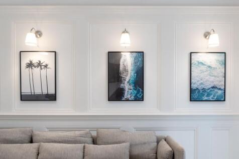 Bright contemporary living room wall with three...