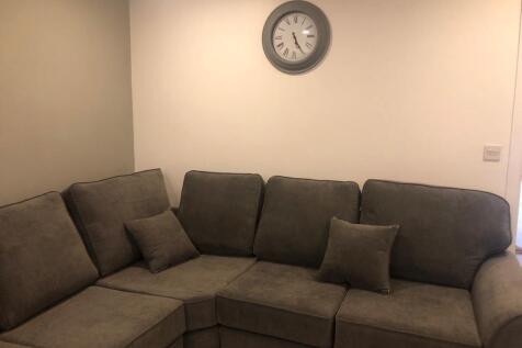 Bright, neutral living room with a comfortable ...