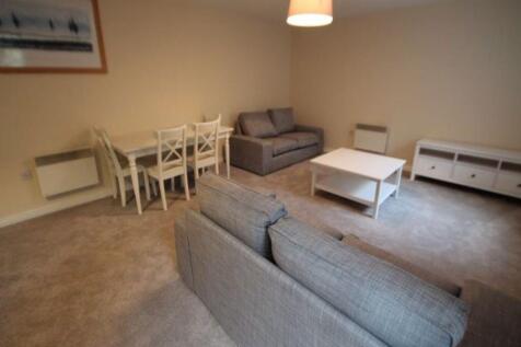 Bright, neutral living room with matching grey ...