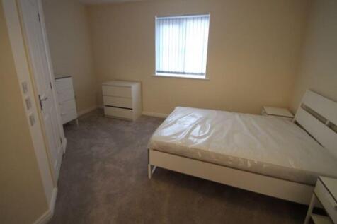 Bright, neutrally decorated double bedroom with...