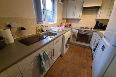 Neat fitted kitchen with ample counter space, i...