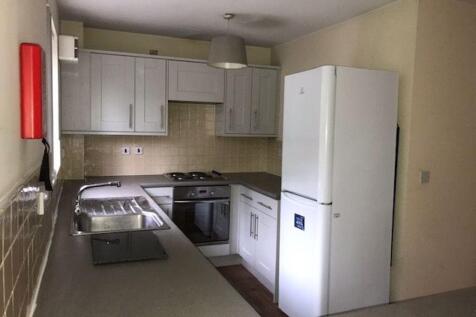 Bright, modern fitted kitchen with ample counte...