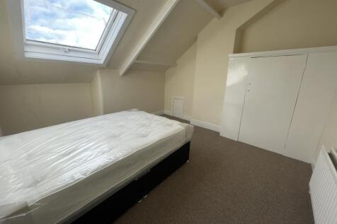 Bright attic double bedroom with a large skylig...
