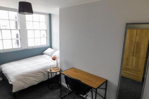 A bright and inviting bedroom with a comfortabl...