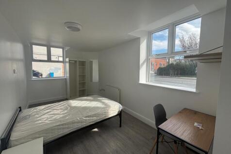Spacious double bedroom featuring large windows...