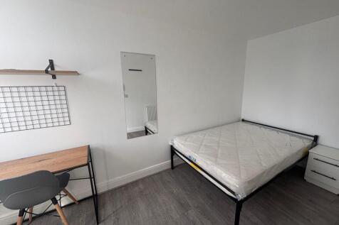 A bright and inviting double bedroom featuring ...