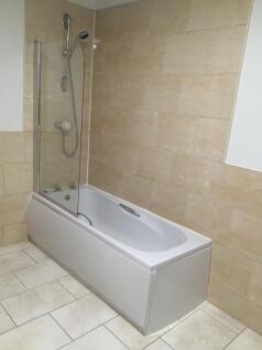 A clean and modern bathroom featuring a spaciou...