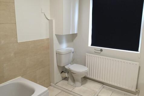 A clean and functional bathroom with a toilet, ...