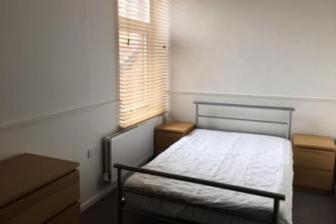 A bright, clean double bedroom featuring a mini...