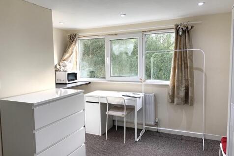 A bright and tidy single bedroom featuring a wh...