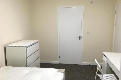 A neat and simple single bedroom featuring a wh...