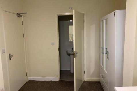 A simple and functional room featuring a door l...