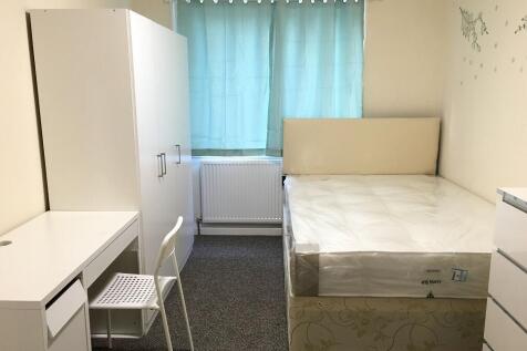 A neat and well-lit double bedroom featuring a ...