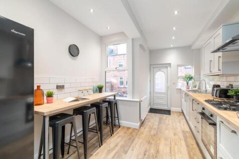 Bright modern galley kitchen with a breakfast b...