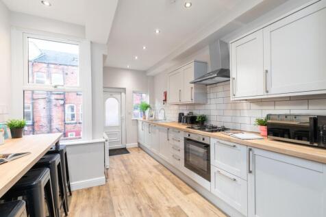 Bright modern kitchen with light cabinetry, int...