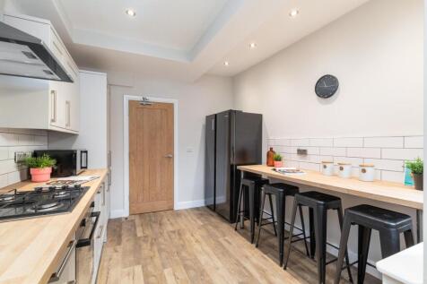 Modern kitchen with fitted units, wooden workto...