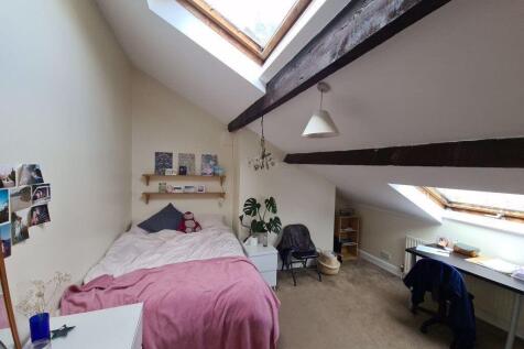 Bright attic-style double bedroom with sloped c...