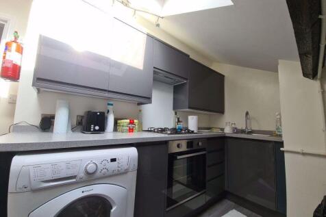 Modern fitted kitchen with integrated oven, was...