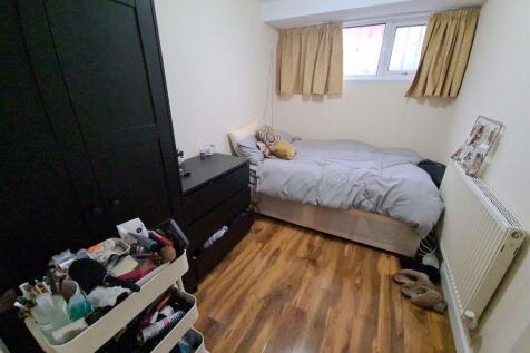 Neat, furnished bedroom with a double bed, fitt...
