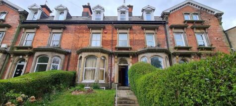 Attractive red-brick terraced house frontage wi...