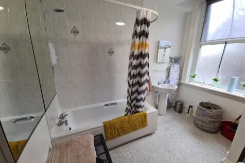 Bright, well-kept bathroom with a full bath and...