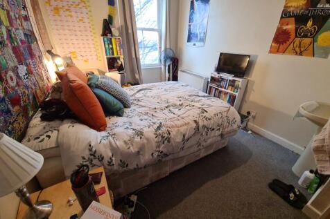Bright, cosy double bedroom with a patterned be...