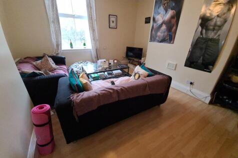 Bright, furnished living room with laminate flo...