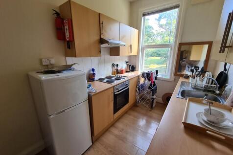 Bright galley kitchen with natural light from a...