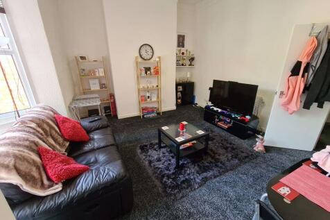 Bright, well-kept communal living room with a l...