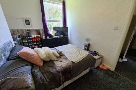 Bright, cozy furnished bedroom with a double be...