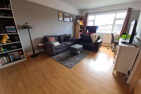 Bright, modern living room with large window, t...