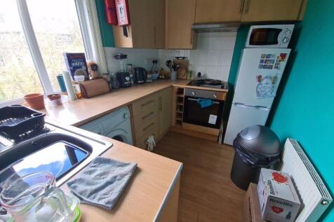 Bright, modern kitchen with integrated oven, mi...