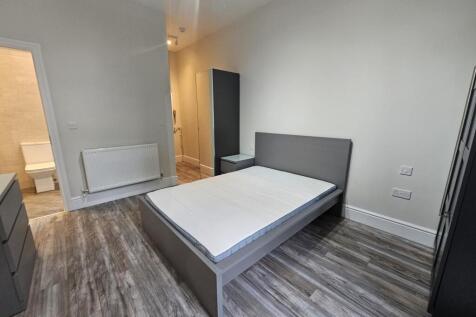 Bright, modern bedroom with a double bed, match...