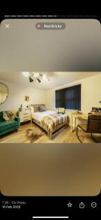 A cozy, well-furnished bedroom featuring a sing...