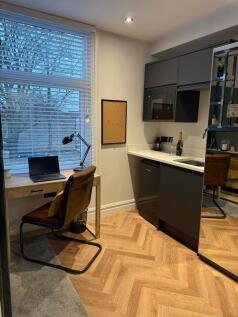 A modern and tidy workspace featuring a wooden ...