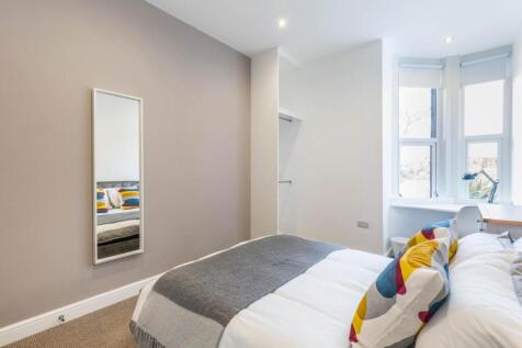 Bright, neatly presented bedroom with a comfort...