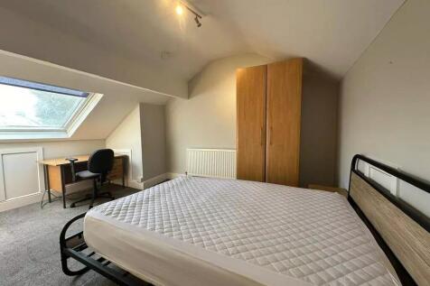 Bright and spacious master bedroom featuring a ...