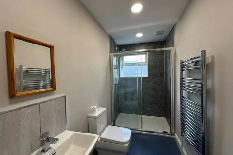 Modern bathroom featuring a sleek walk-in showe...