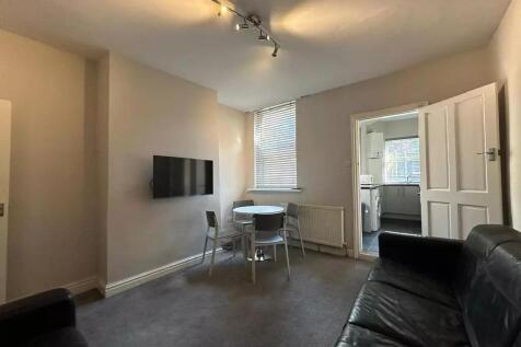 A comfortable living room featuring leather sof...